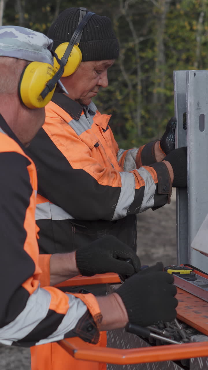 Construction workers operating heavy machinery