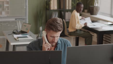 two diverse stock traders working together in office