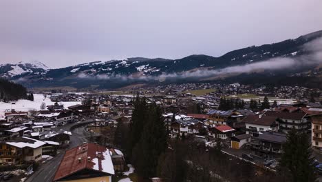 Iconic-township-of-Kirchberg-on-misty-day,-aerial-hyper-lapse-view