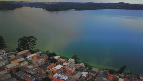 Aerial-birds-eye-view-flying-towards-the-water-reserve-lake-in-Sao-Paulo