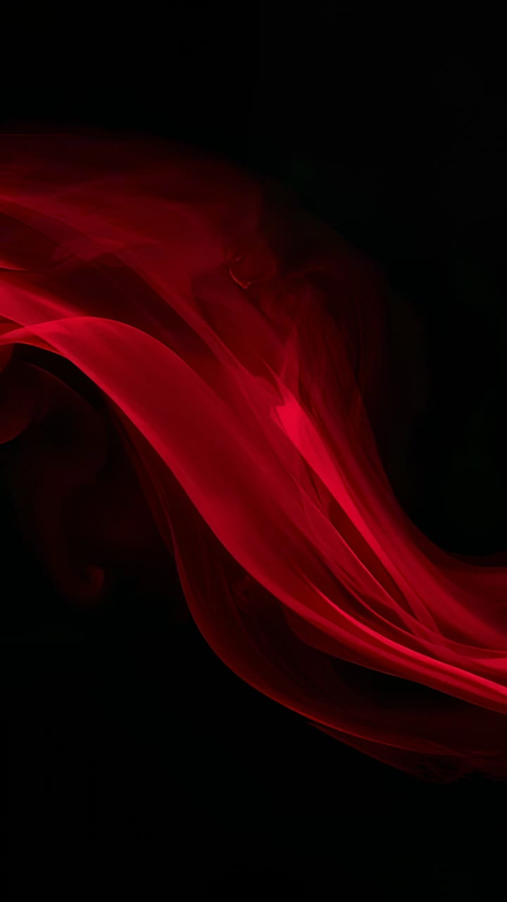 Vertical video: Entering left red ribbon flowing over black backdrop, glow brightening as slow flow