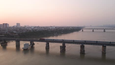 Train-running-on-the-bridge-over-the-river-in-the-morning-dawn