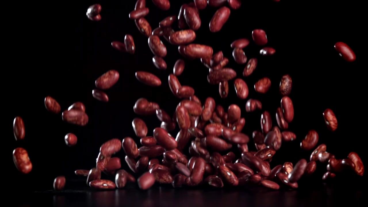 Red Kidney Beans Falling in Slow Motion on Black Background