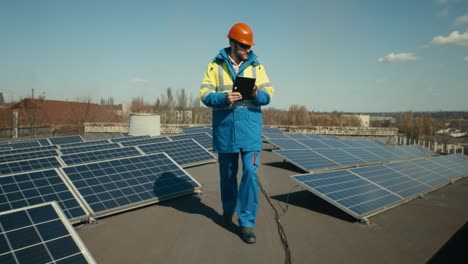 technician inspecting solar panels on rooftop