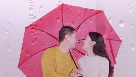 animation of raindrops over happy asian couple with umbrella