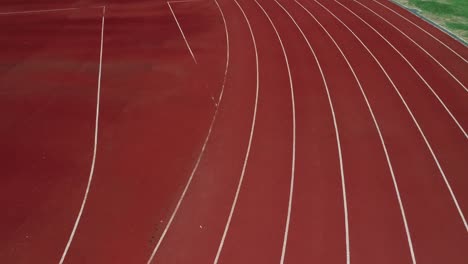 running track at the stadium, color is orange brick, high angle view by drone.