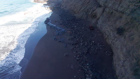 Aerial-view-along-the-shore-of-the-virgin-Faneroque-beach-in-Agaete,-on-the-island-of-Gran-Canaria