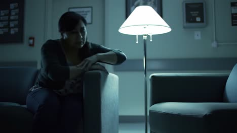 A Contemplative Moment in a Dimly Lit Waiting Area: Exploring Isolation and Reflection in an Emotional Setting