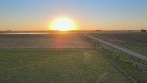 road running through the pampas in la pampa, argentina, sunset drone