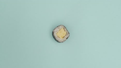 Sushi-roll-rotating-on-blue-background