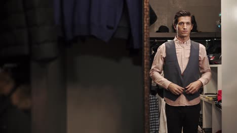 man trying on clothes in a dressing room