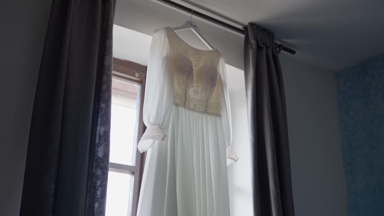 Luxurious white wedding dress in the bride's room during preparations for the ceremony