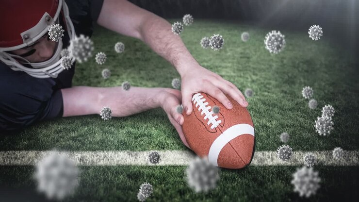 Animazione di cellule Covid-19 che cadono su un giocatore di football americano.