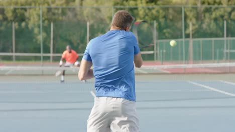 caucasian male tennis player celebrating point against diverse opponent on court in slow motion