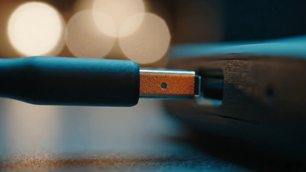 Close-Up of USB Connection: A Detailed Comparison of Connecting and Disconnecting Cables with Blurred Background Lights for Enhanced Visual Focus