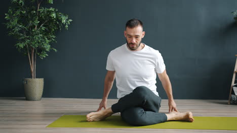 man practicing seated yoga poses
