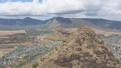 Mountain-cliffside-with-mountain-range-view-on-tropical-island-near-the-beach-and-suburban-housing