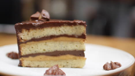 rack focus three layered chocolate caramel cake dessert