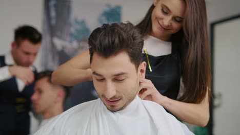 Handheld-view-of-handsome-man-sitting-in-hair-salon