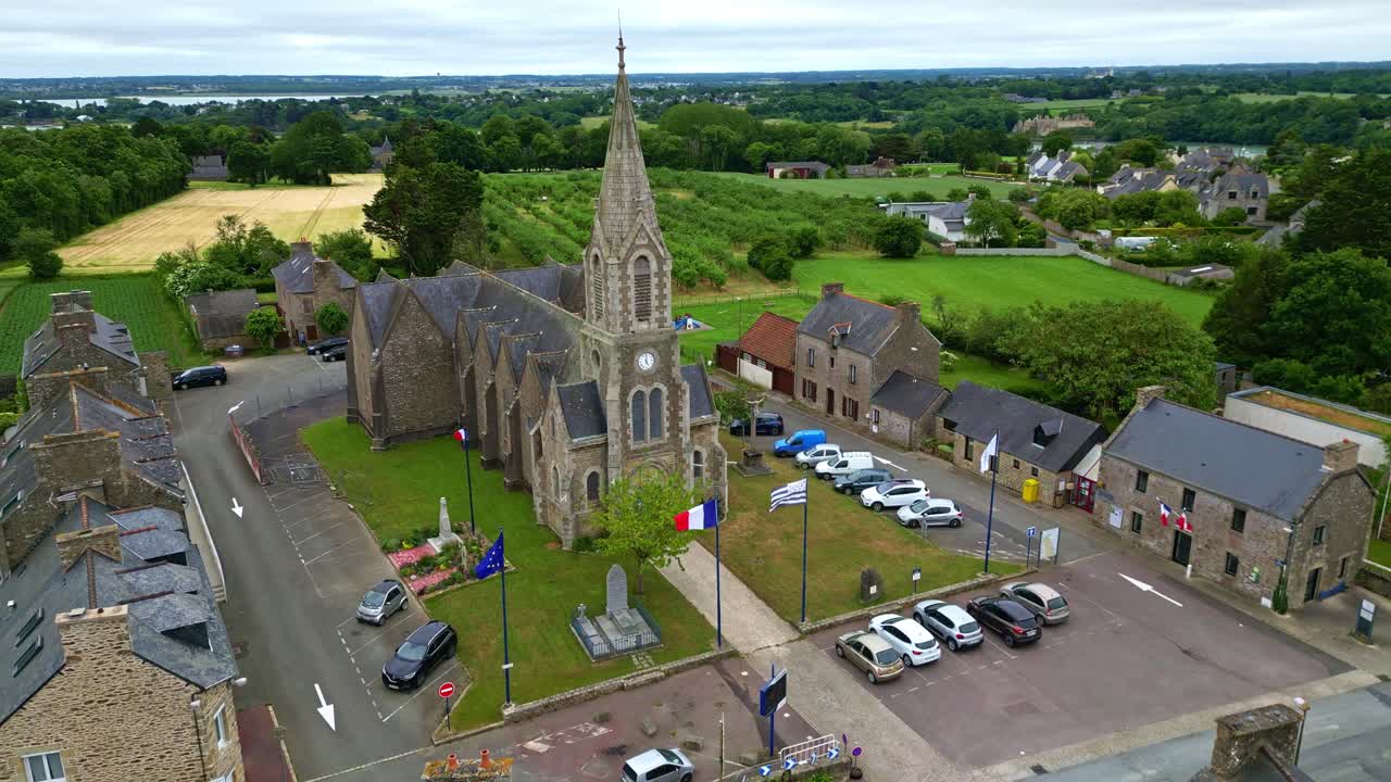 Smooth backward drone movement from the Church of Notre-Dame-du-Guildo in Saint-Cast-le-Guildo, Côtes-d'Armor, Brittany, France.