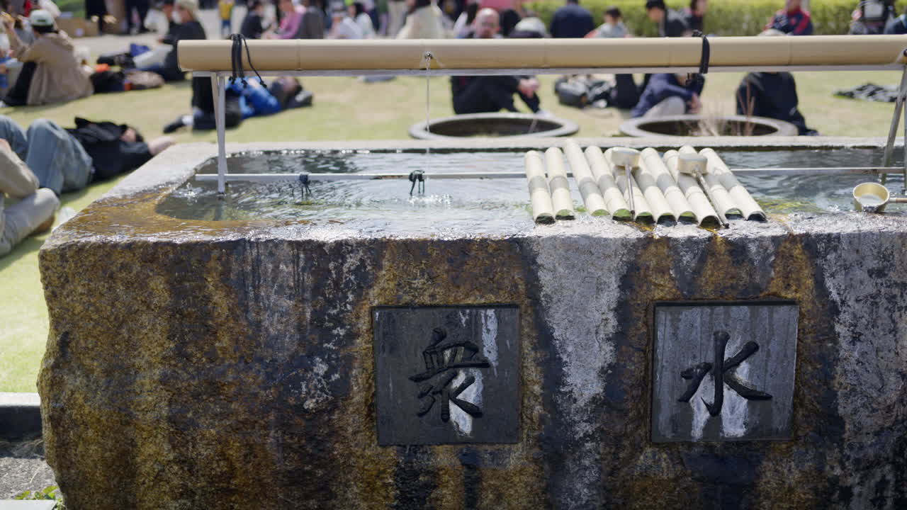 Close up of a purification fountain in the court of the Tsukiji Hongan-ji Temple in Chuo, Japan. Translation: "ritual water"