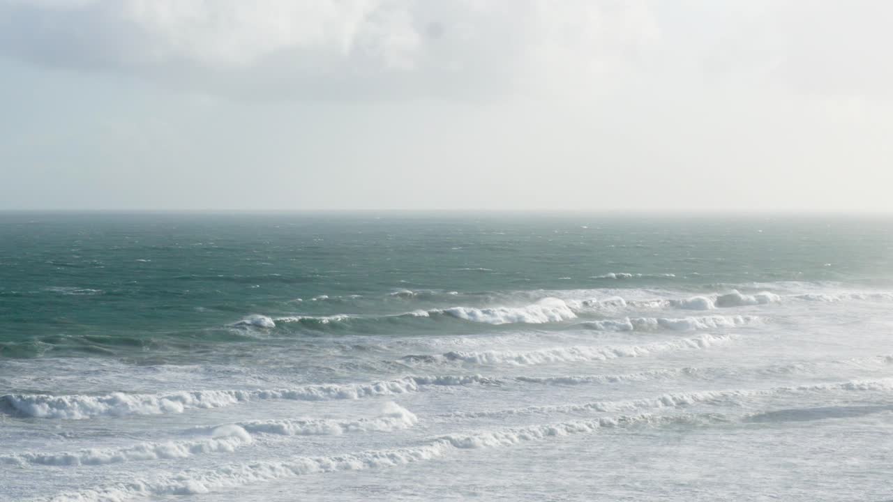 Dynamic ocean waves under cloudy skies along Melbourne's Great Ocean Road, captured with steady camera work and natural lighting