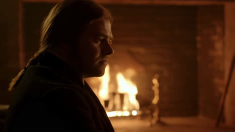 man by the fireplace