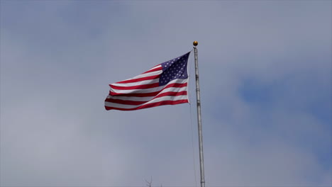 an american flag fluttering in the breeze in slo-motion