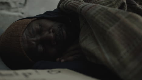 man resting under a blanket