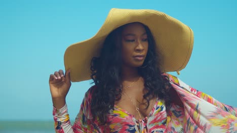 African-black-girl-closeup-of-her-face-while-holding-a-big-straw-hat