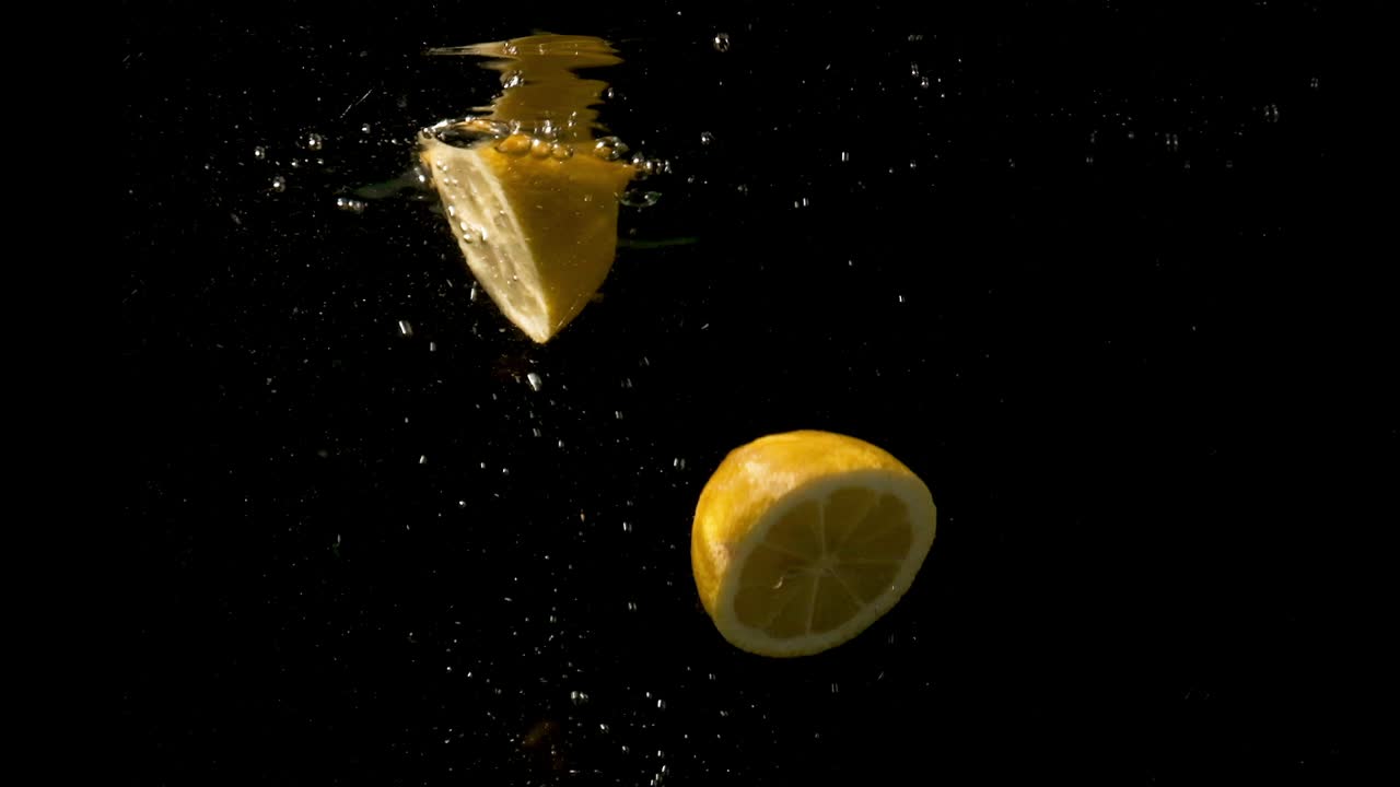Sliced Lemons Dropped And Taken Out Of The Water -wide shot