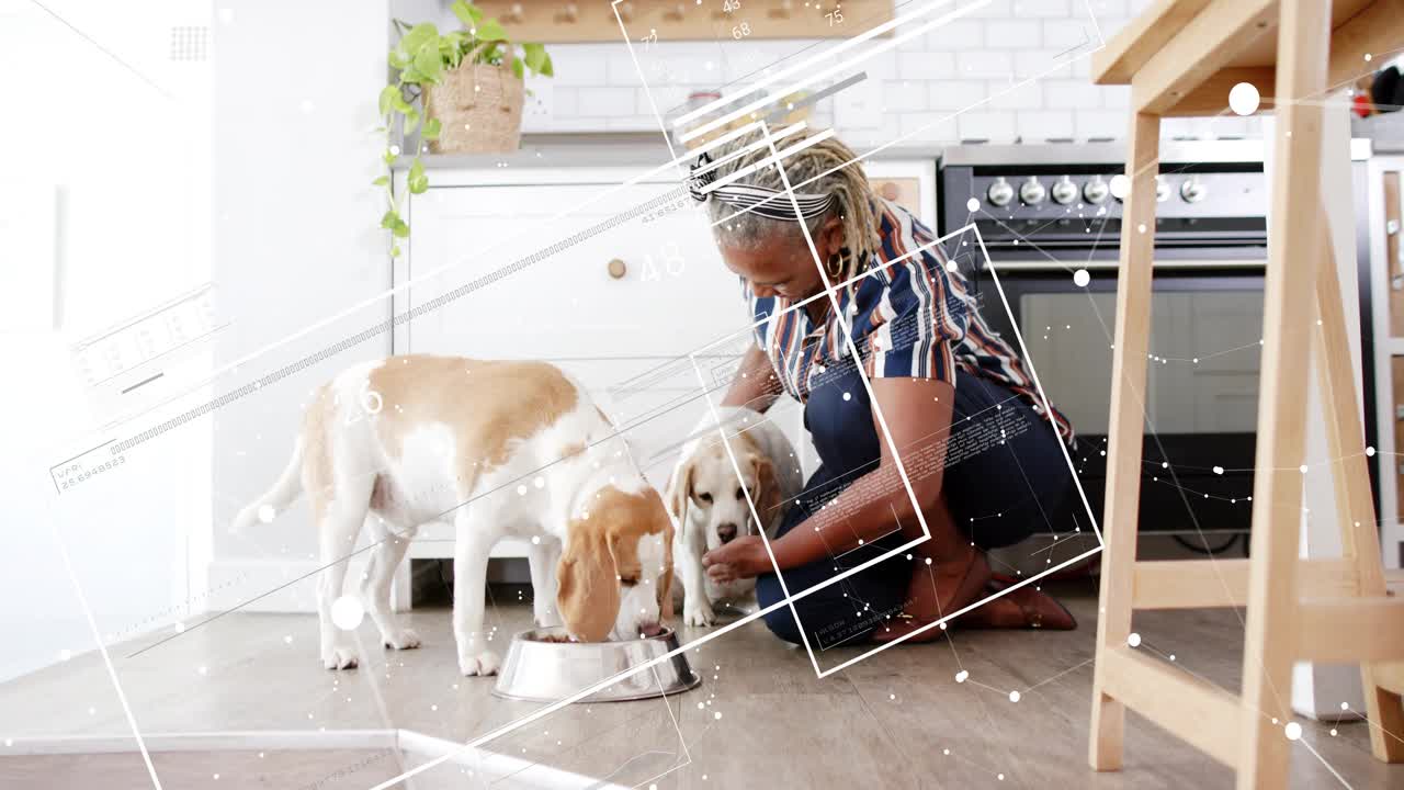 Senior woman kneeling placing bowl, guiding two dogs feeding together while AI HUD overlaying scene