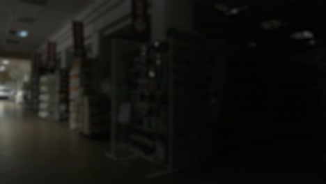 blurred background. the lights in the emty supermarket turn on. shopping mall
