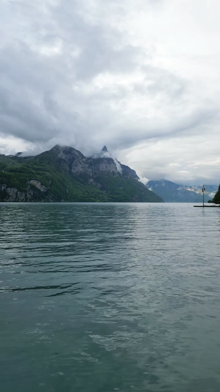Man walking towards Lake Walen Walensee Swiss alpine Switzerland nature