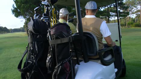 Two-golfers-driving-in-their-golf-buggy-