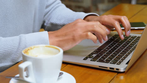 man using laptop in cafeteria 4k