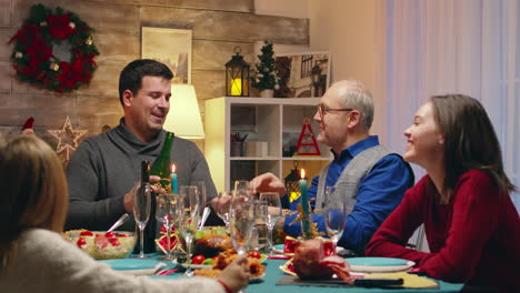 adult man pouring champagne for his father