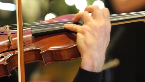 Violin-being-played-with-symphony-during-the-holidays