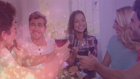 animation of lights over happy caucasian male and female friends toasting with wine