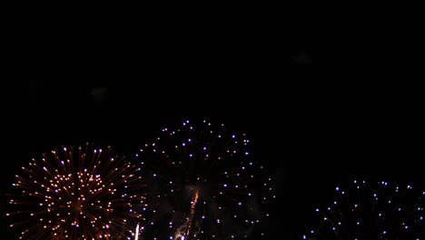 international fireworks festival showing pyrotechnics display of multicolored lights bursting in the dark cold night at a beachfront in a popular tourist destination in southeast asia