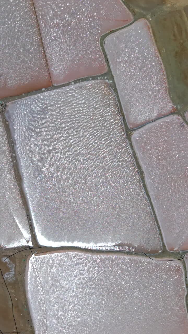 Stunning vertical video close-up of glistening salt crystals forming geometric shapes at Salinas de Manaure, La Guajira. Natural sunlight highlights texture. Ideal for mobile, social reels