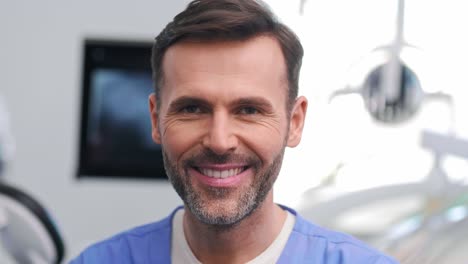 portrait of smiling male stomatologist at work