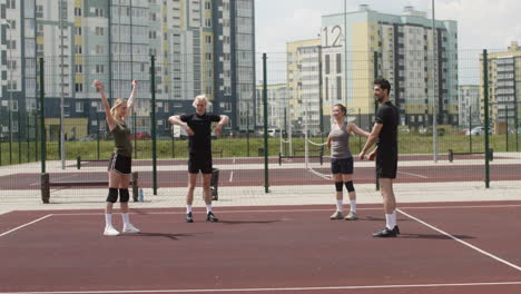 group of multiethnic friends in sportswear stretching