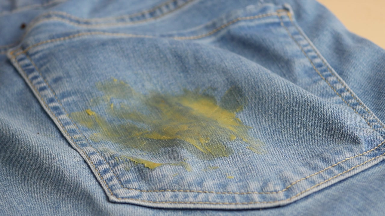 Close-up of a Yellow Stain on Blue Denim Jeans