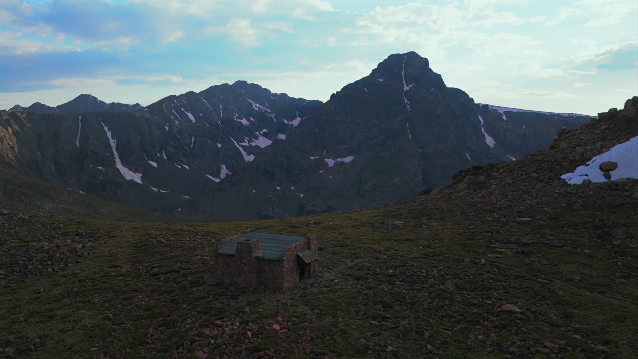 Notch Mountain Shelter Halo Ridge landscape view of Mount of the Holy Cross 14er peak wilderness aerial drone Colorado summer afternoon sunset clouds Rocky Mountains Sawatch Range forward motion