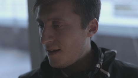 close-up of a man looking out a window