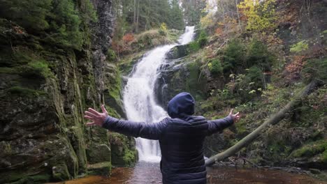 a mantraveler near a waterfall a sense of freedom active recreation in a mountainous area a mantraveler near a waterfall a sense of freedom active recreation in a mountainous area