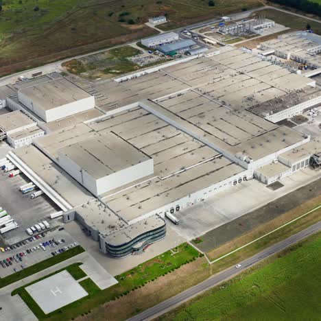 industrial zone in environment. large factory with car parking on field. modern industrial plant frome above. aerial view