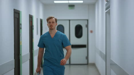 serious doctor walking down hospital corridor. medic going in clinic hallway.