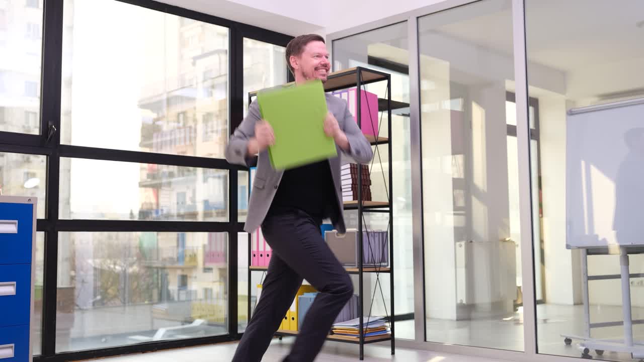 Excited Businessman Running with Folders in Modern Office